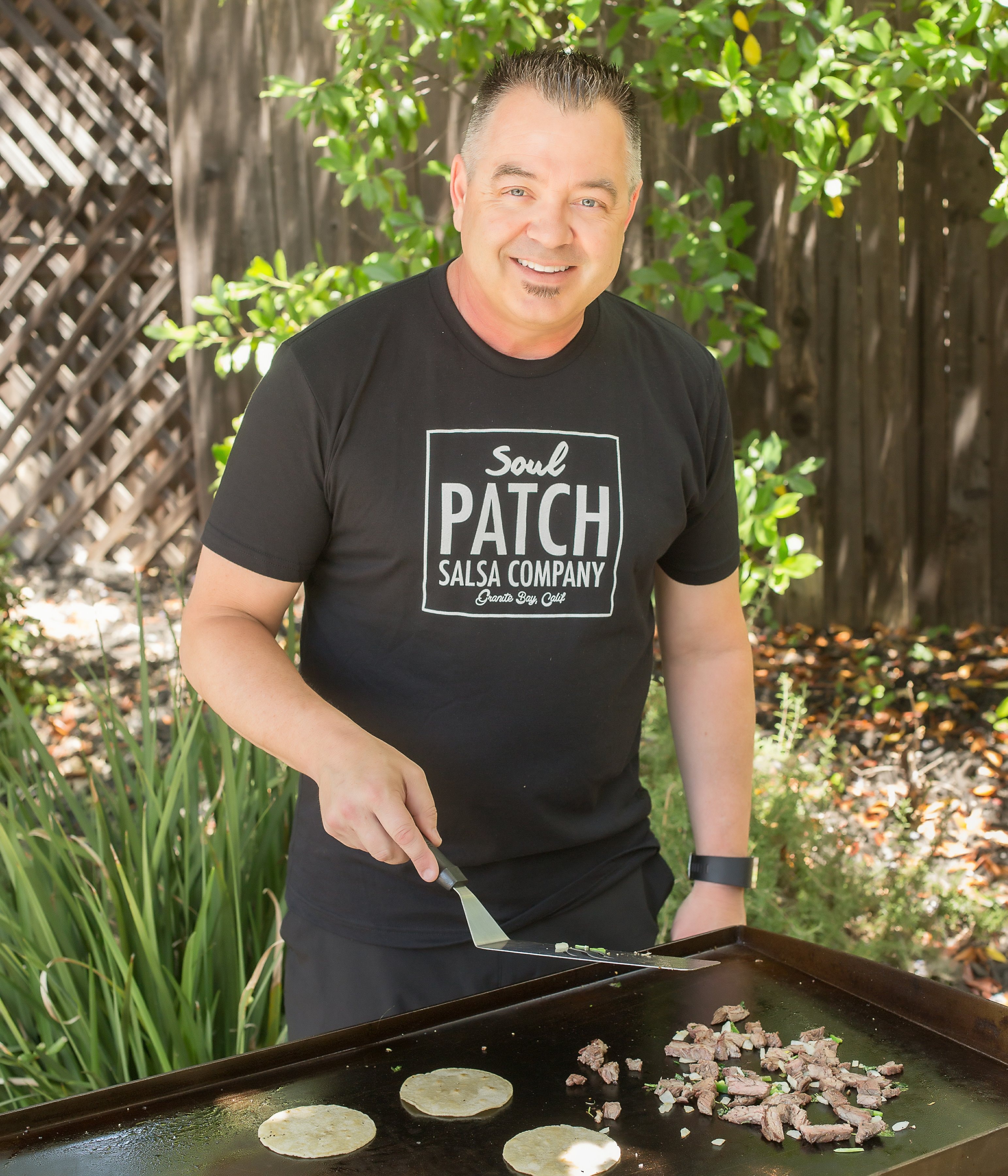 Sean McMenamin, owner of Soul Patch Salsa Co., cooking on a griddle